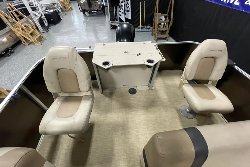 Slide: The Image of 2018 Crestliner FS 220 boat interior with beige seating and console. - 10