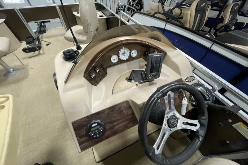 Slide: The Image of 2018 Crestliner FS 220 boat dashboard with steering wheel and navigation instruments. - 13