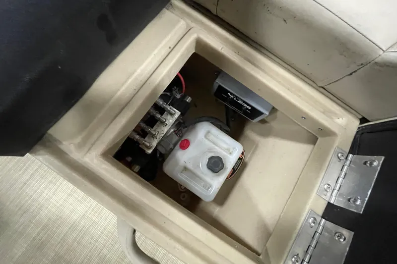 Slide: The Image of Storage compartment in a 2018 Crestliner FS 220 boat, featuring a fuel tank and electrical components. - 14