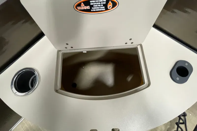 Slide: The Image of 2018 Crestliner FS 220 boat storage compartment with cup holders and warning label. - 15