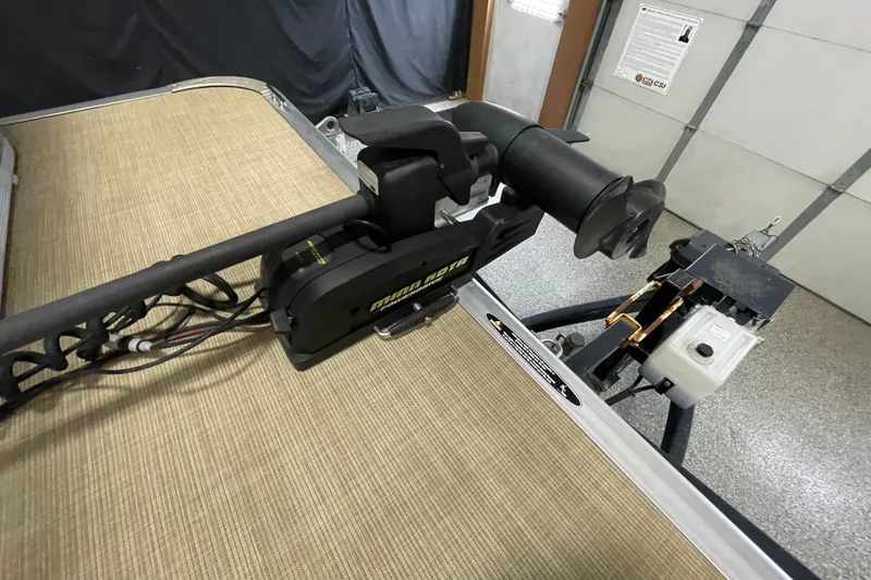 Slide: The Image of 2018 Crestliner FS 220 boat with Minn Kota trolling motor in a garage setting. - 18