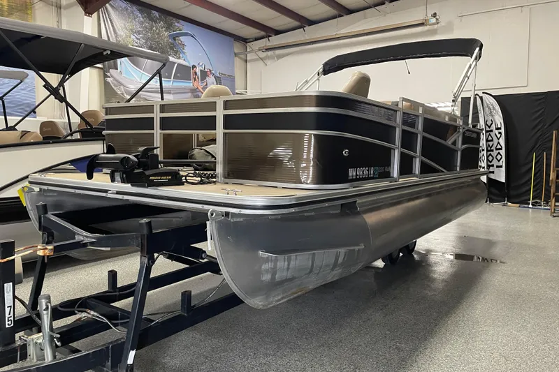 Slide: The Image of 2018 Crestliner FS 220 pontoon boat in showroom, side view with trailer. - 4