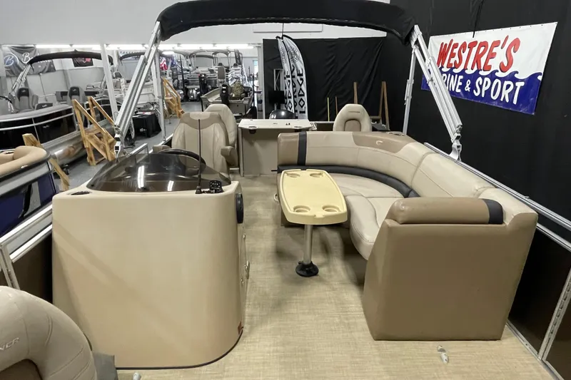 Slide: The Image of 2018 Crestliner FS 220 boat interior with beige seating and table, displayed at Westre's Marine & Sport. - 7
