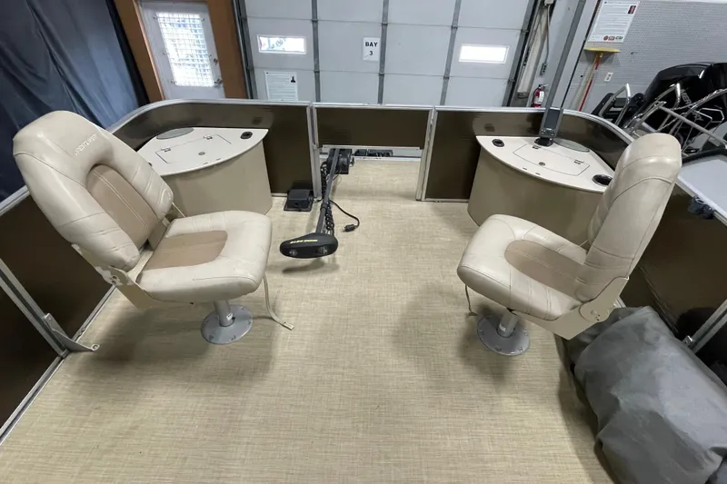 Slide: The Image of 2018 Crestliner FS 220 boat interior with two beige swivel seats and control panels. - 8