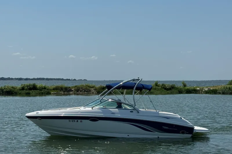 Slide: The Image of 2001 Chaparral 230 SSi boat on calm water with scenic background. - 0