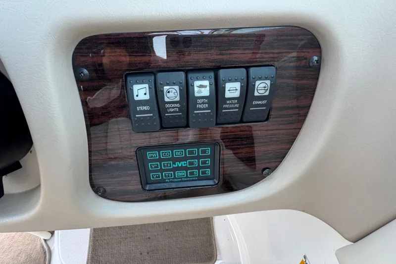 Slide: The Image of Control panel of a 2001 Chaparral 230 SSi boat with various switches and buttons. - 10