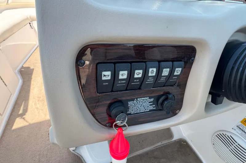 Slide: The Image of Control panel of a 2001 Chaparral 230 SSi boat with labeled switches and ignition keys. - 11