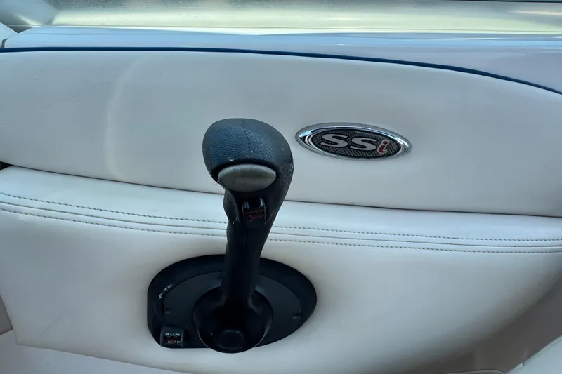 Slide: The Image of Throttle control of 2001 Chaparral 230 SSi boat with SSI logo on white interior. - 12