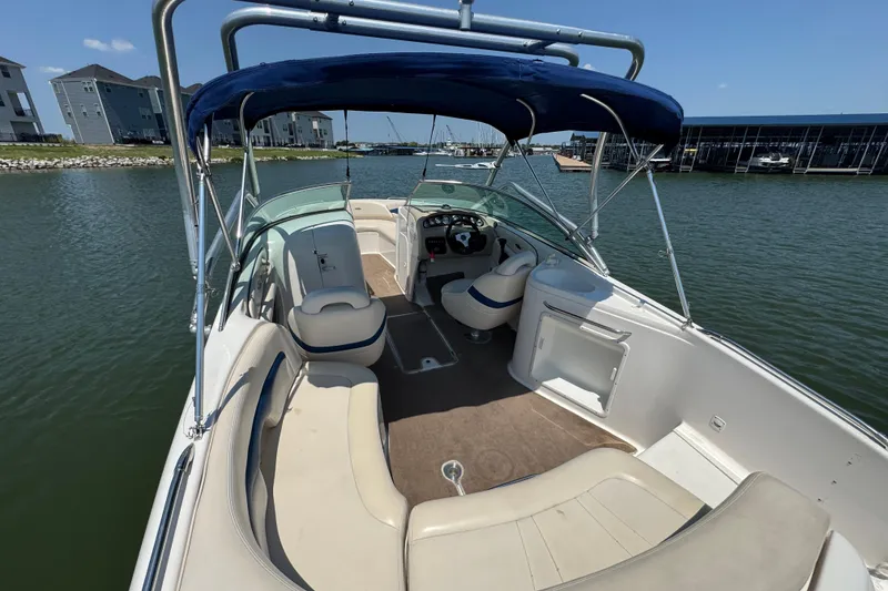 Slide: The Image of 2001 Chaparral 230 SSi boat interior with seating and canopy on a sunny day. - 15