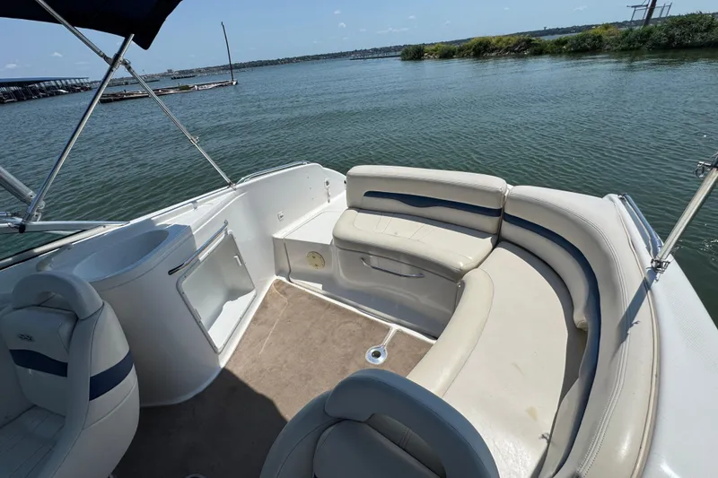 Slide: The Image of 2001 Chaparral 230 SSi boat interior with seating, on a sunny day by the water. - 17