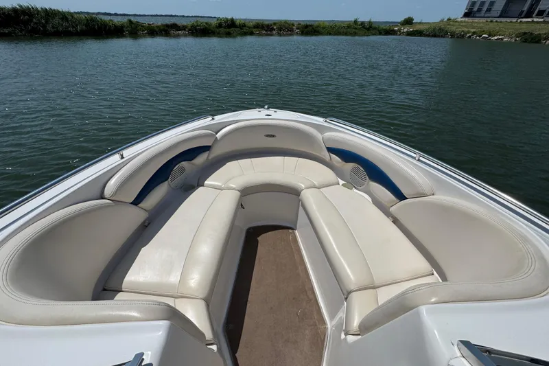 Slide: The Image of 2001 Chaparral 230 SSi boat interior with white seating on calm water. - 5
