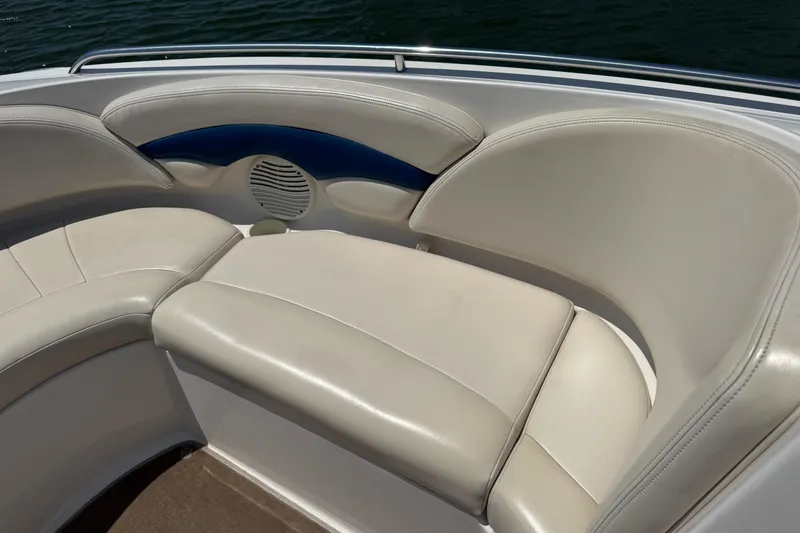 Slide: The Image of 2001 Chaparral 230 SSi boat interior with white cushioned seating and speaker. - 6