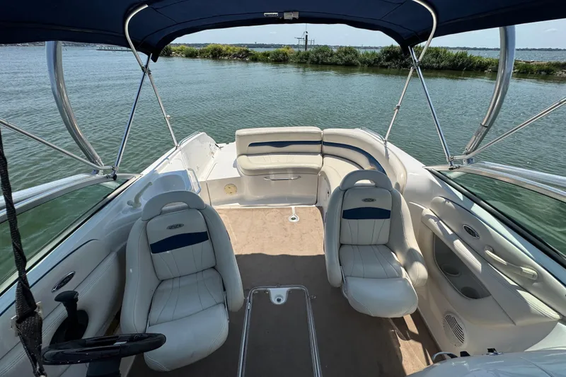Slide: The Image of 2001 Chaparral 230 SSi boat interior with seating, canopy, and water view. - 7