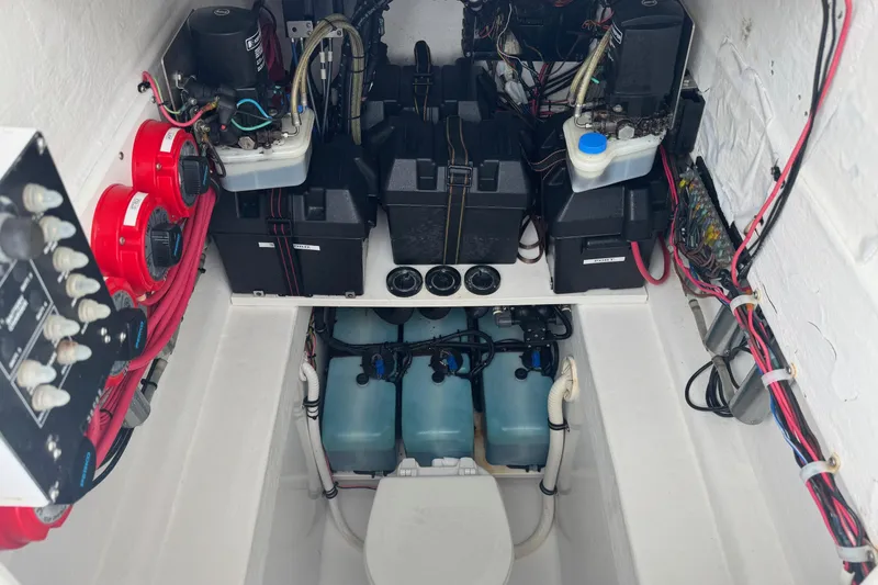 Slide: The Image of Engine compartment of a 2002 Contender 36 Open boat, showcasing wiring and components. - 10