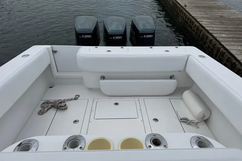 Slide: The Image of 2002 Contender 36 Open boat with triple V250 engines at dockside. - 12