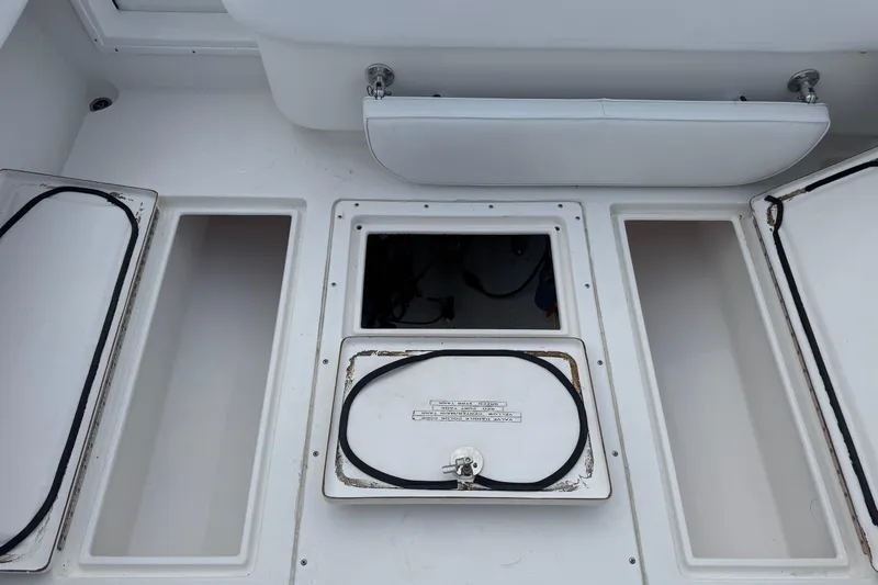 Slide: The Image of 2002 Contender 36 Open boat storage compartments with open hatches. - 17