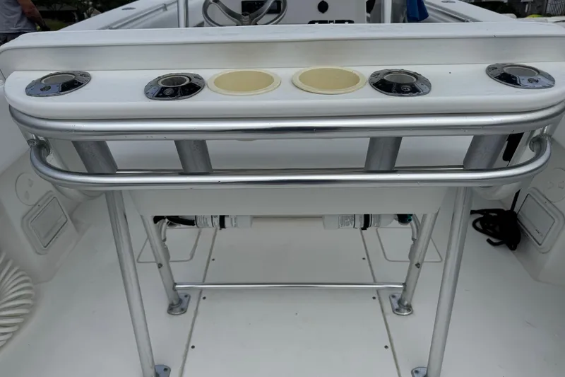 Slide: The Image of 2002 Contender 36 Open boat console with rod holders and cup holders. - 19