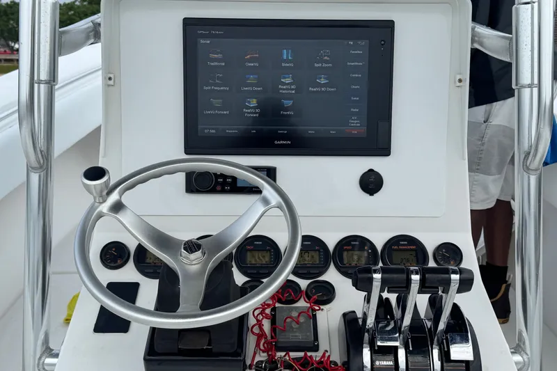 Slide: The Image of Control panel of a 2002 Contender 36 Open boat with Garmin display and steering wheel. - 21