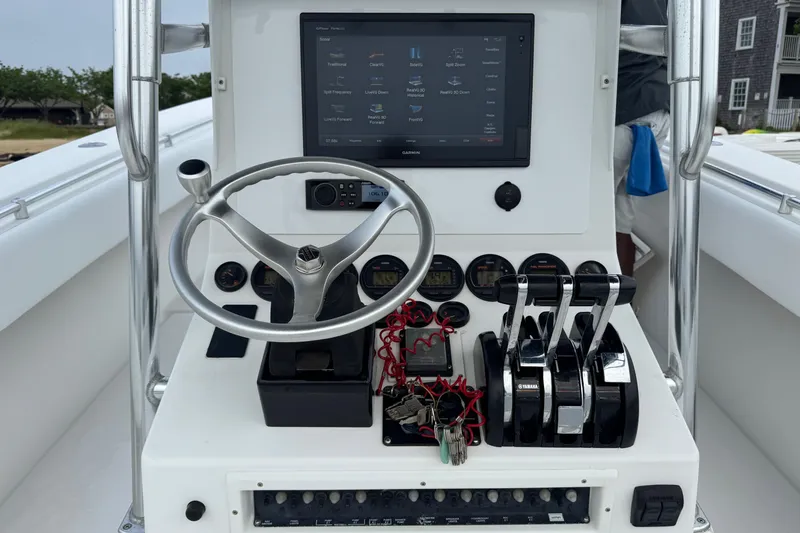Slide: The Image of Control panel of a 2002 Contender 36 Open boat with steering wheel and navigation display. - 22