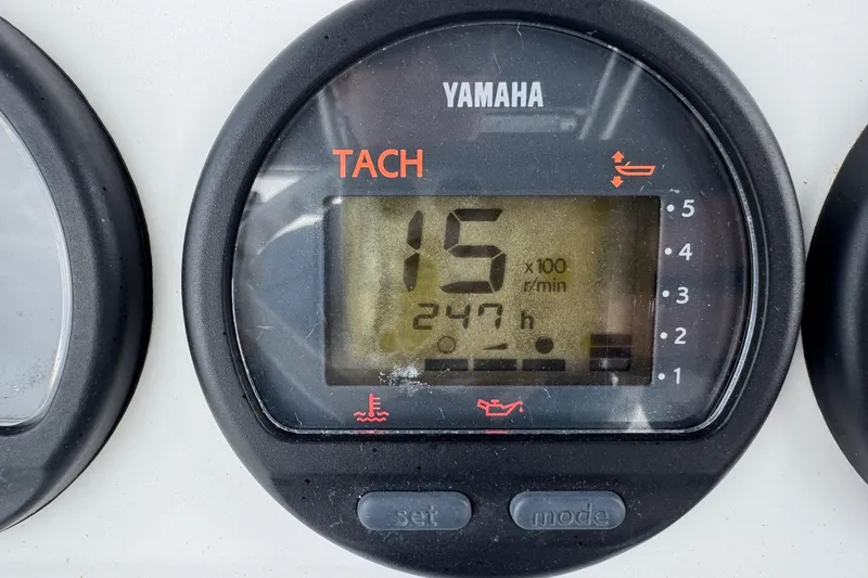 Slide: The Image of Yamaha tachometer displaying 1500 RPM and 247 hours on a 2002 Contender 36 Open boat. - 23