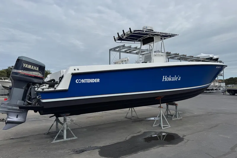 Slide: The Image of 2002 Contender 36 Open boat with Yamaha outboard engine, displayed on stands. - 4