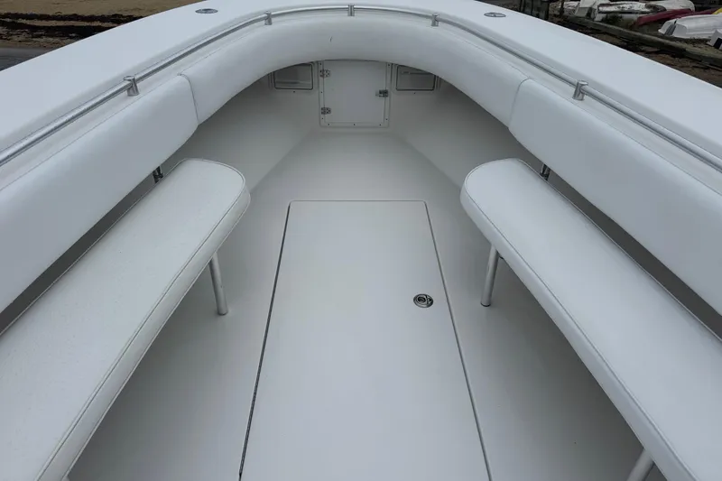 Slide: The Image of 2002 Contender 36 Open boat interior with white seating and storage compartments. - 5