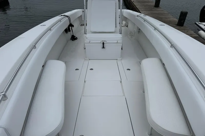 Slide: The Image of 2002 Contender 36 Open boat interior with white seating and deck, docked by the water. - 6