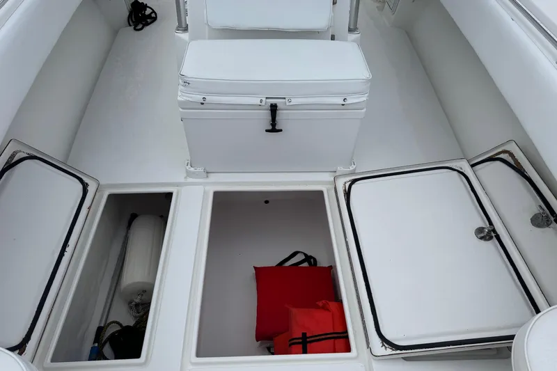 Slide: The Image of 2002 Contender 36 Open boat storage compartments with safety gear and equipment. - 9
