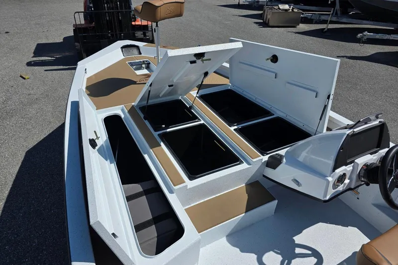 Slide: The Image of 2026 Xpress H20 Bass boat interior with open storage compartments and steering console. - 12