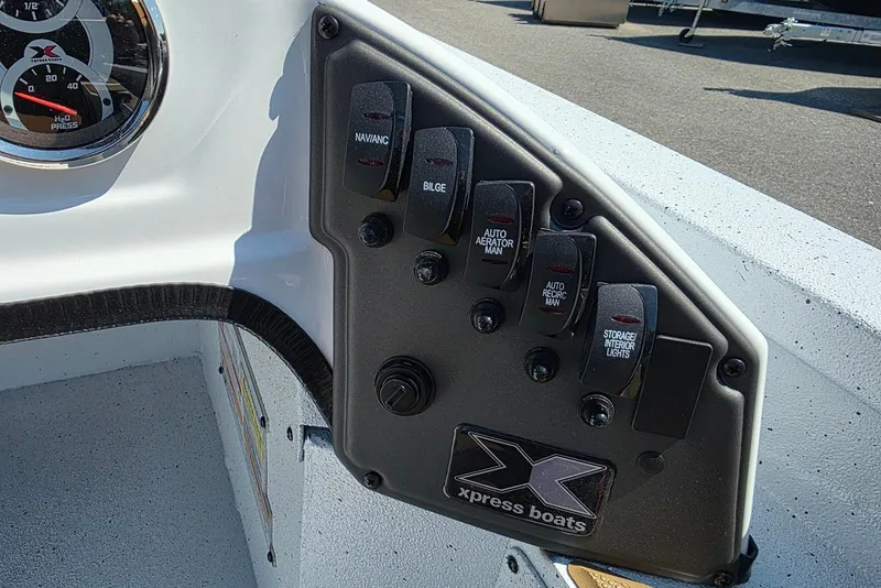 Slide: The Image of Control panel of 2026 Xpress H20 Bass boat with switches and gauges. - 16