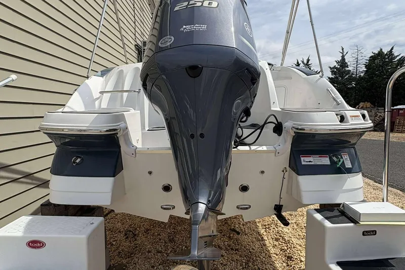 Slide: The Image of 2023 Hurricane SD 2400 boat with powerful outboard motor, parked on gravel. - 15