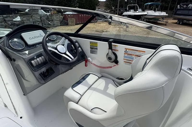 Slide: The Image of 2023 Hurricane SD 2400 boat cockpit with Garmin navigation and white captain's seat. - 4
