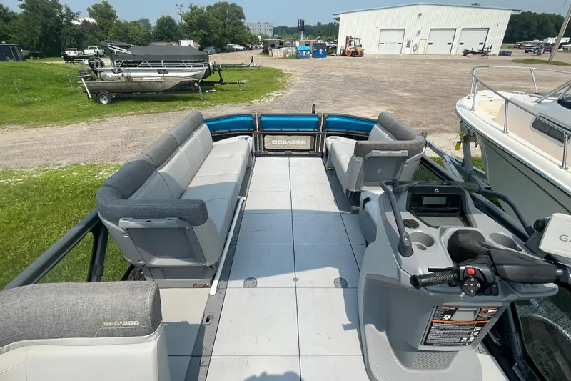 Slide: The Image of 2023 Sea-Doo Switch 21-230 pontoon boat interior with spacious seating and control console. - 6