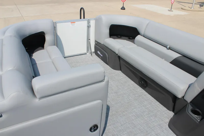 Slide: The Image of 2026 Sun Tracker Party Barge 20 DLX interior with gray seating and spacious layout. - 11