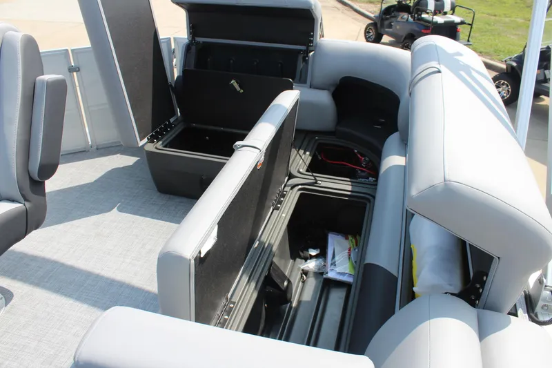 Slide: The Image of 2026 Sun Tracker Party Barge 20 DLX interior with open storage compartments. - 16