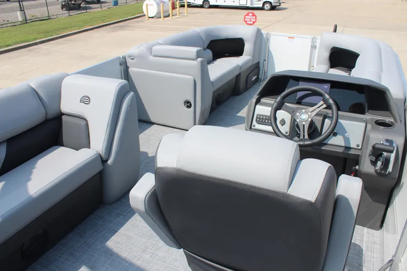 Slide: The Image of 2026 Sun Tracker Party Barge 20 DLX interior with plush seating and modern helm. - 17