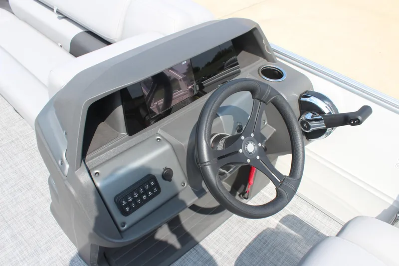 Slide: The Image of 2026 Sun Tracker Party Barge 20 DLX steering console with modern controls and sleek design. - 20