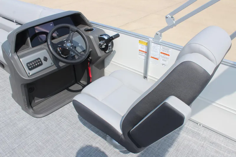 Slide: The Image of 2026 Sun Tracker Party Barge 20 DLX helm with steering wheel and captain's chair. - 21