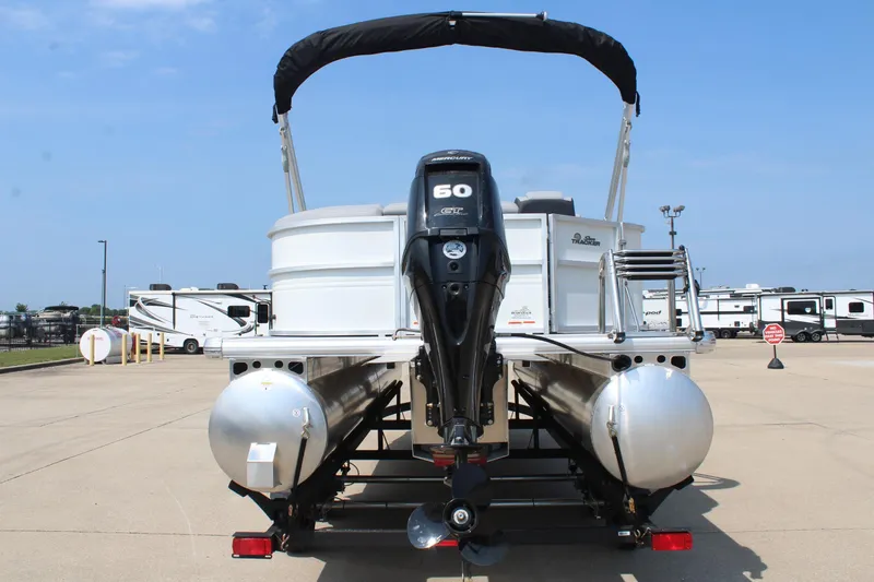 Slide: The Image of 2026 Sun Tracker Party Barge 20 DLX pontoon boat with Mercury 60 engine, parked outdoors. - 3