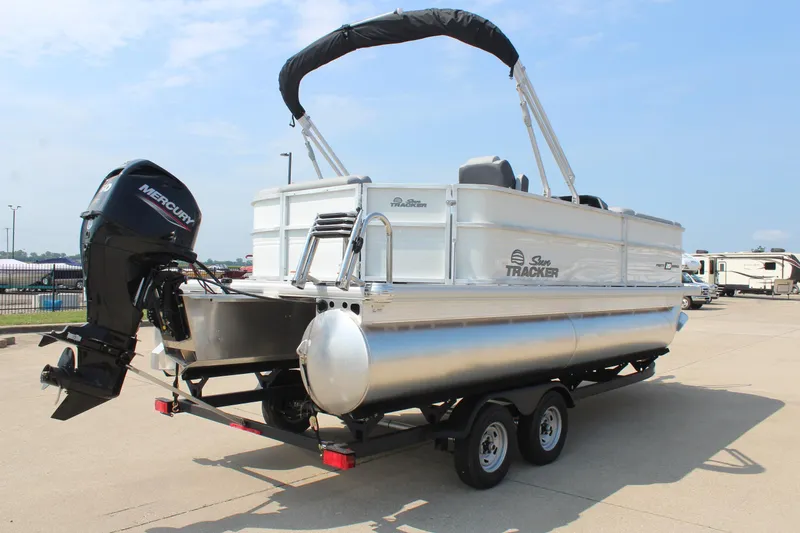 Slide: The Image of 2026 Sun Tracker Party Barge 20 DLX pontoon boat with Mercury outboard motor on trailer. - 4
