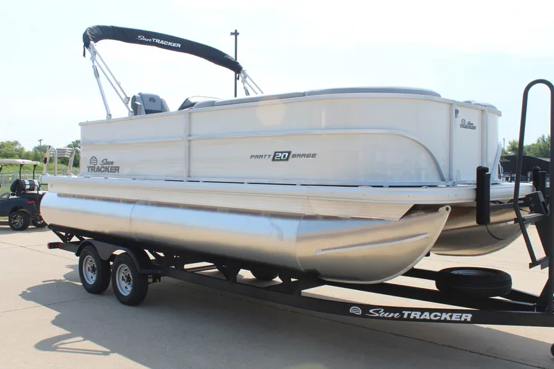 Slide: The Image of 2026 Sun Tracker Party Barge 20 DLX pontoon boat on trailer, side view. - 6