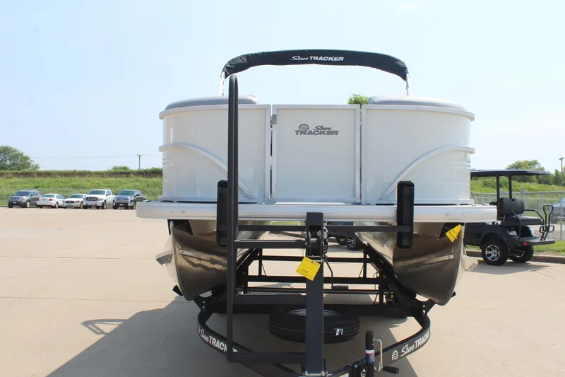 Slide: The Image of 2026 Sun Tracker Party Barge 20 DLX pontoon boat on trailer, parked outdoors. - 7