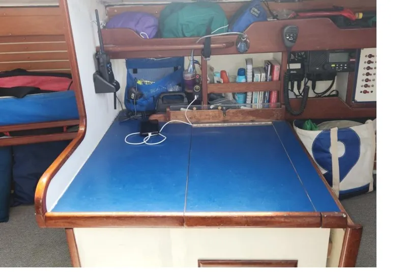 Slide: The Image of Navigation station on a 1984 Custom Peacock 35 sailboat with blue desk and equipment. - 12