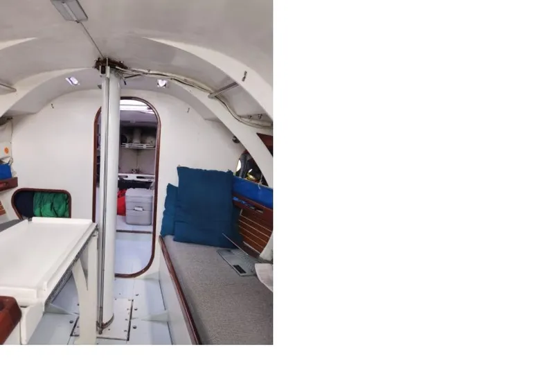Slide: The Image of Interior of a 1984 Peacock 35 sailboat, featuring seating and storage areas. - 3