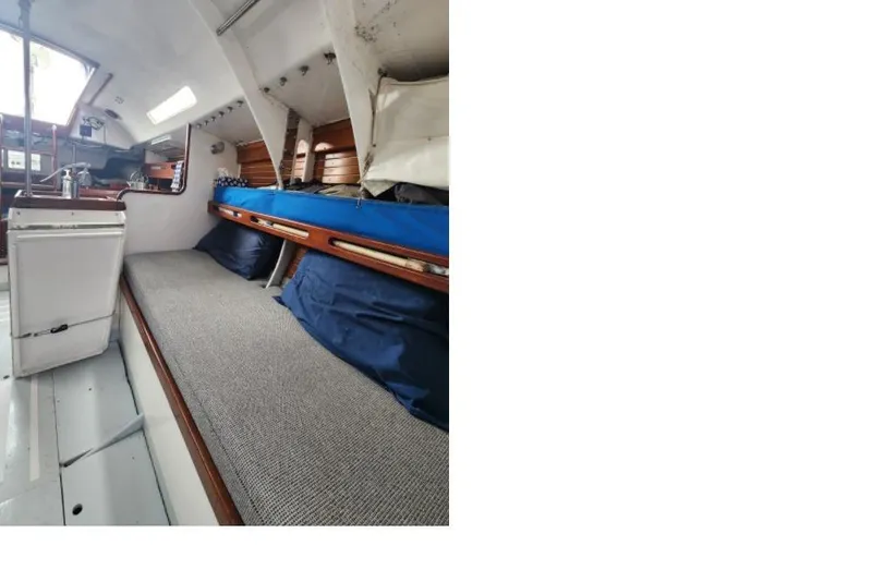 Slide: The Image of Interior of 1984 Peacock 35 sailboat with cozy sleeping area and storage. - 4