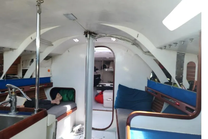 Slide: The Image of Interior of a 1984 Peacock 35 sailboat, featuring cozy seating and nautical decor. - 6