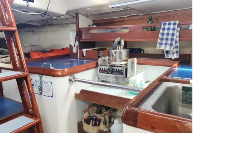Slide: The Image of Interior of 1984 Peacock 35 boat kitchen with stove, sink, and wooden cabinetry. - 9