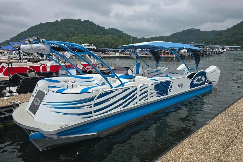 The Image of 2026 Aloha Pontoon Paradise Twin X32 docked on a scenic lake with lush hills. - 0