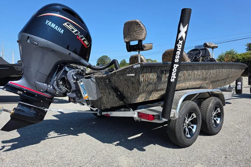 Slide: The Image of 2026 Xpress H20 Bass boat with Yamaha engine on a trailer, camo design. - 12