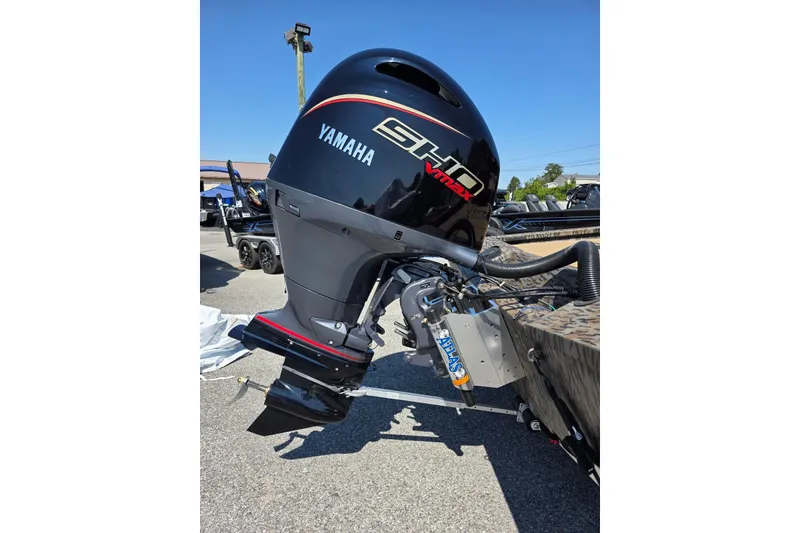 Slide: The Image of 2026 Xpress H20 Bass boat with Yamaha VMAX outboard motor, parked outdoors. - 13